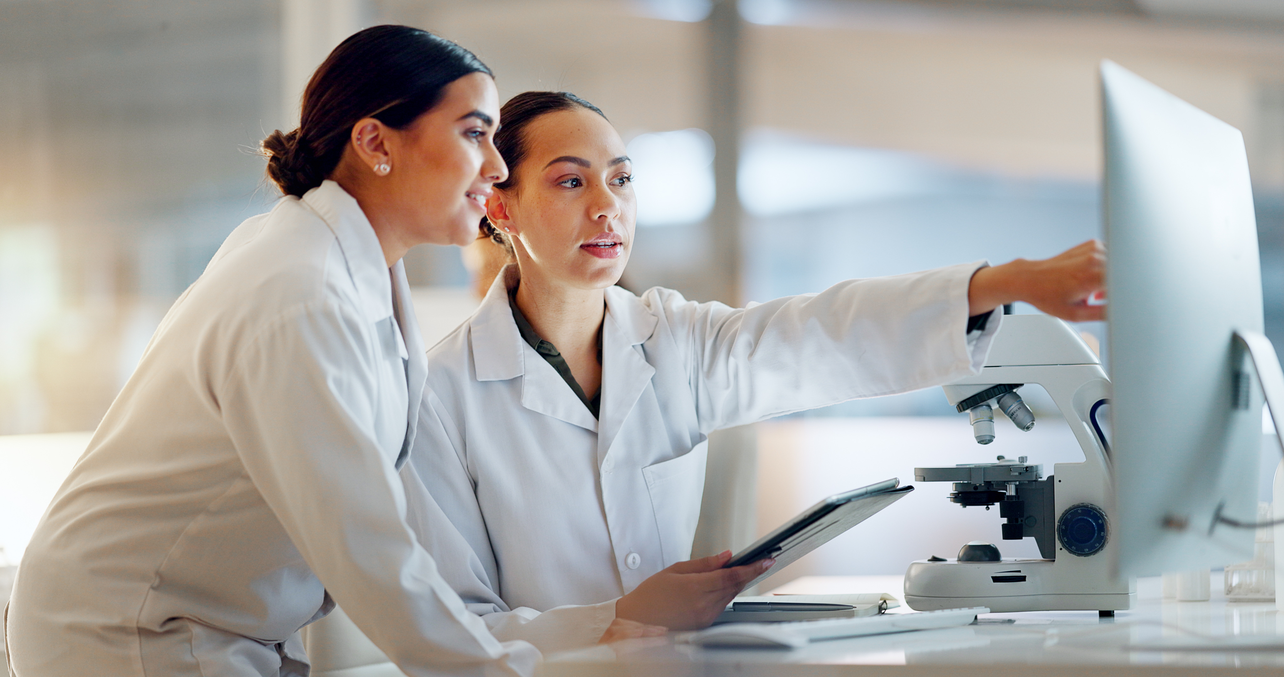 Two scientists discussing analytical results at a bench